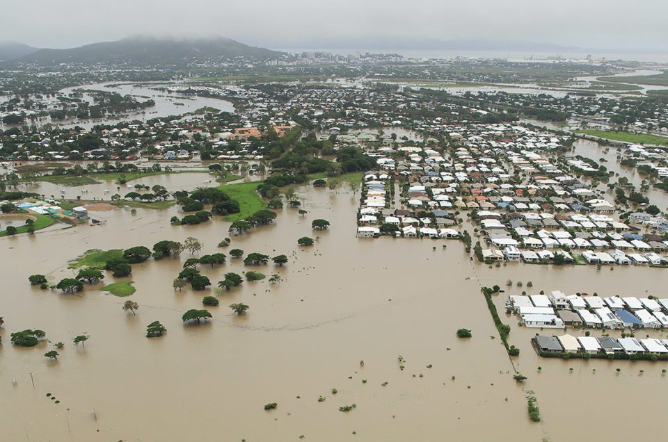 Stranded vehicles are seen from above as floodwater engulfs the intersection of Stuart Drive and the Bruce Highway in Townsville, Monday, February 4, 2019. Hundreds of people still waiting for help and evacuation centres are filling up fast, with unprecedented water releases from the city's swollen dam having sent torrents of water down the Ross River and into the city, swamping roads, yards and homes.